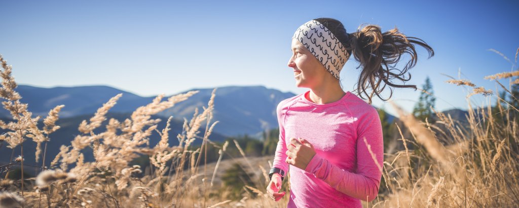 solo runner smiling in nature