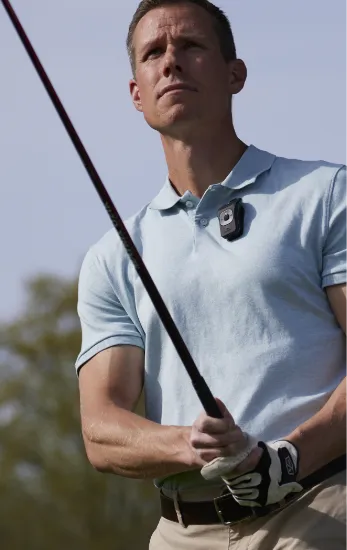 Photo of a man golfing while wearing a 39g on his shirt.