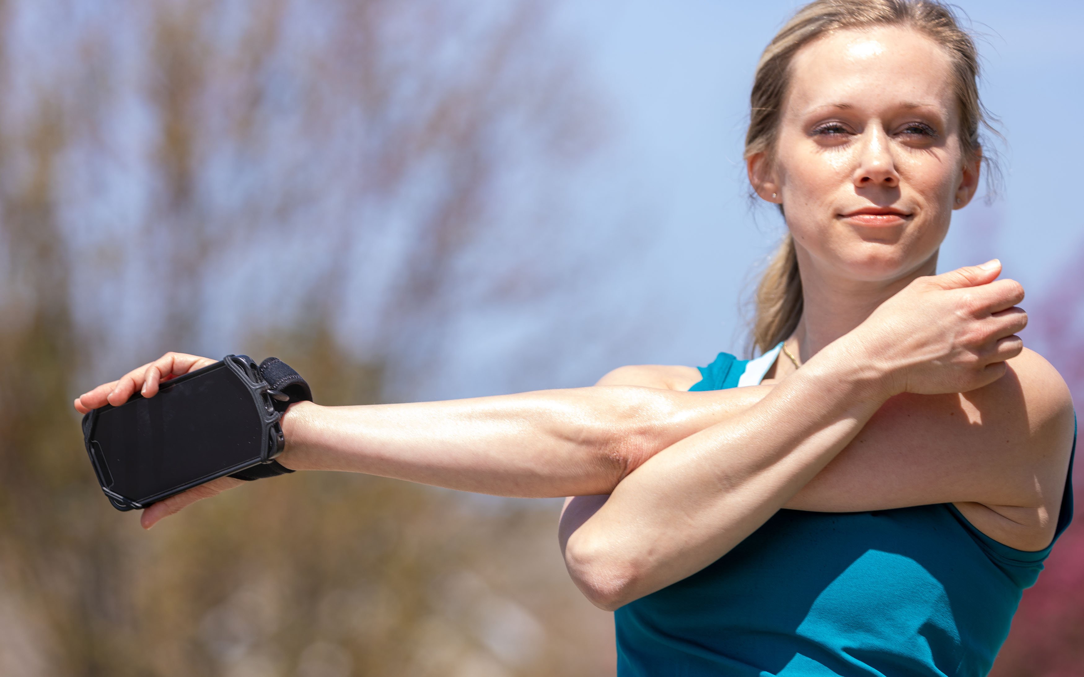 Woman stretching using the Phone Holder.