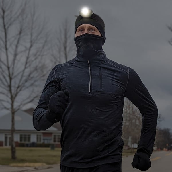 Man running with Head Light on his head.