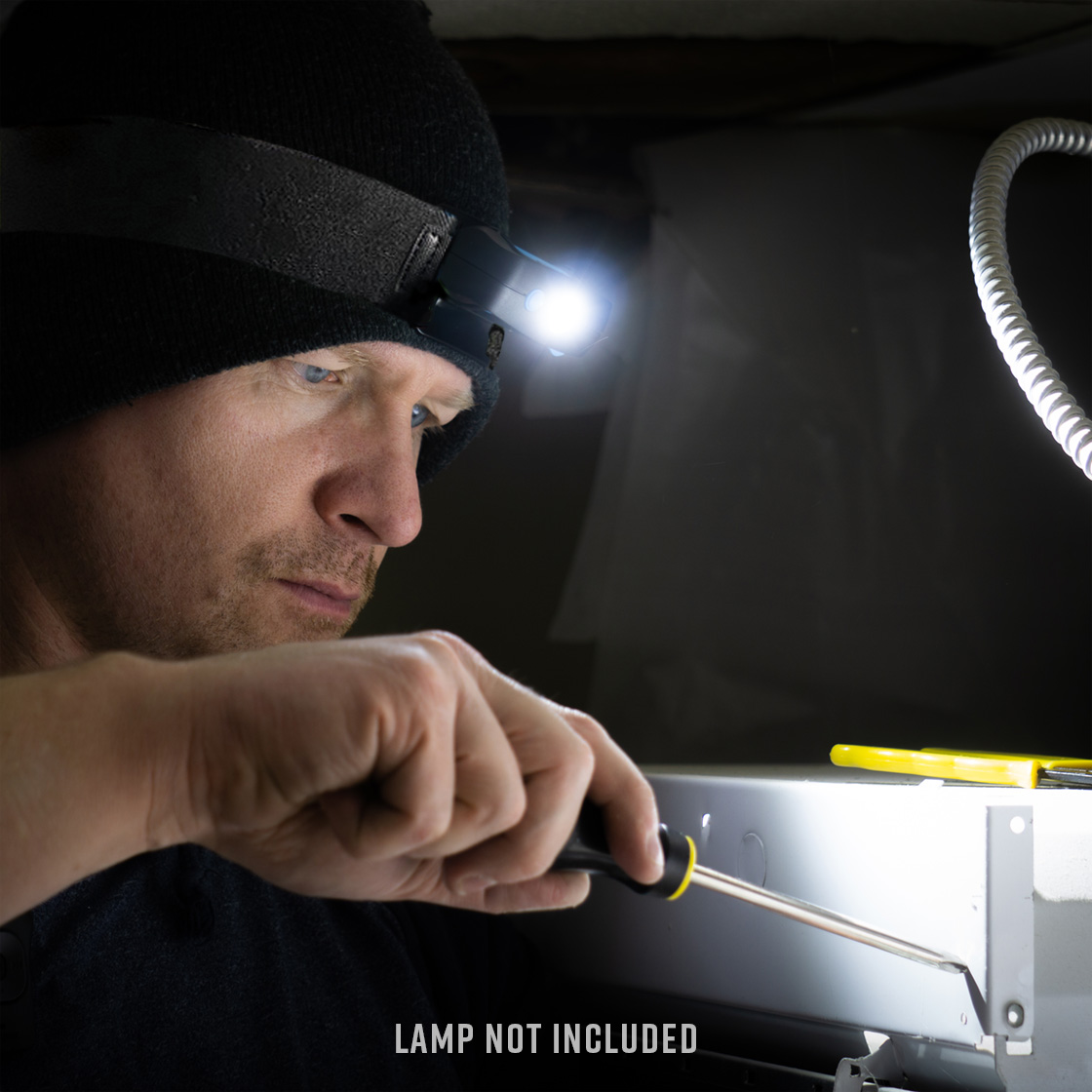 Man using Noxgear Headlamp to illuminate screwdriver use. (Lamp not included in purchase of Head Strap)