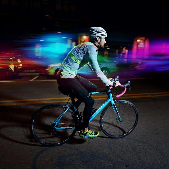 A person riding a bike at night with Tracer2 lights.
