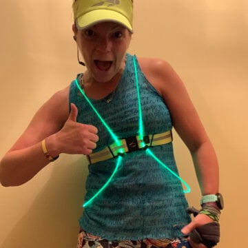 Enthusiastic runner give a thumbs-up in a teal noxgear vest